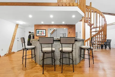 a view of a living room with furniture and wooden floor