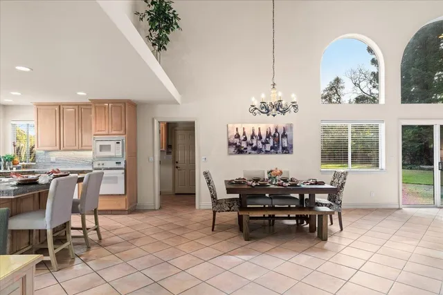 a dining room with furniture and a kitchen view
