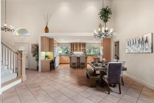 a kitchen with stainless steel appliances granite countertop a stove top oven a sink dishwasher and white cabinets with wooden floor