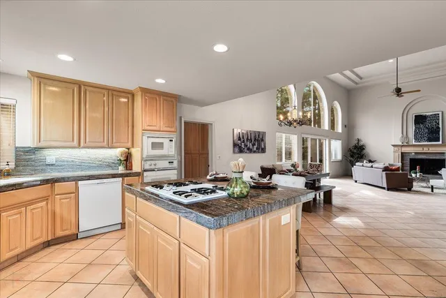 a living room with furniture fireplace and potted plants
