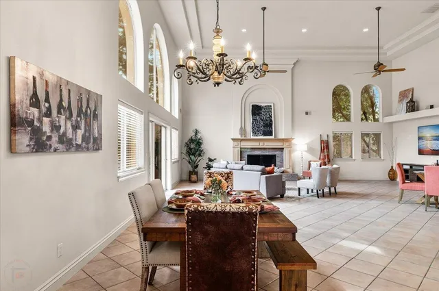 a bedroom with two beds and a chandelier