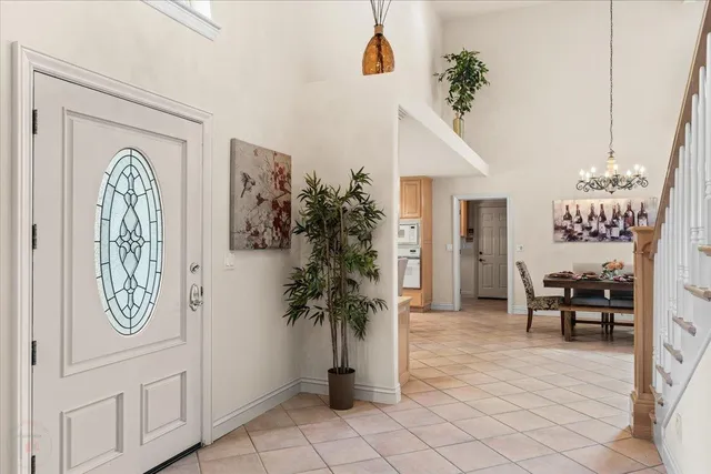 a view of a dining room with furniture and chandelier