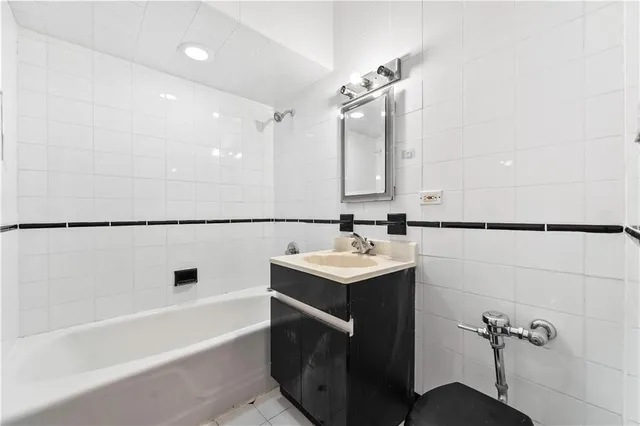 a bathroom with a sink mirror toilet and bathtub