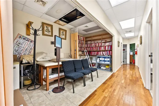 a living room with furniture and a book shelf