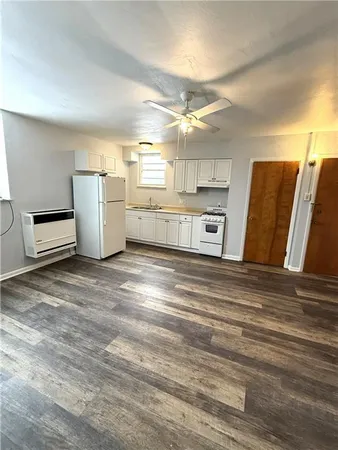 a view of a refrigerator in kitchen and wooden floor
