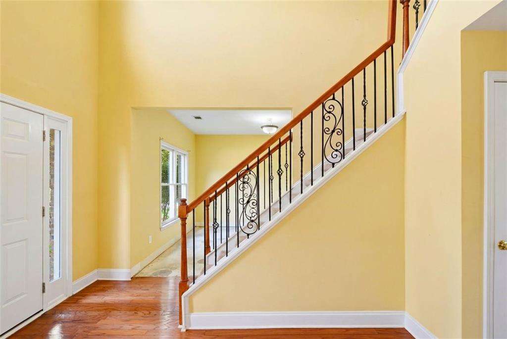 3420 Bulloch Lake Road Loganville, GA 30052 - Photo 28 of 57 a view of staircase with wooden floor and bathroom