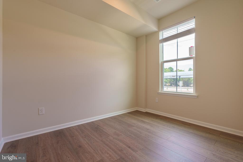 39 Sidney Lane Stratford, NJ 08084 - Photo 14 of 21 an empty room with wooden floor and windows