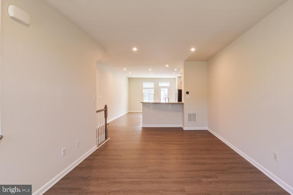 39 Sidney Lane Stratford, NJ 08084 - Photo 4 of 21 a view of a hallway with wooden floor and kitchen