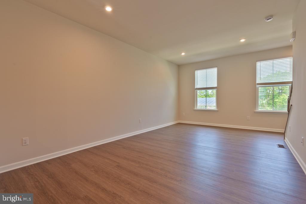 39 Sidney Lane Stratford, NJ 08084 - Photo 5 of 21 an empty room with wooden floor and windows