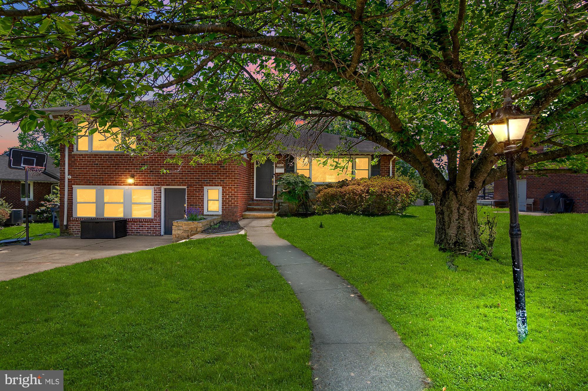 6308 Ivymount Road Baltimore, MD 21209 - Photo 1 of 22 a view of a yard with plants and large trees