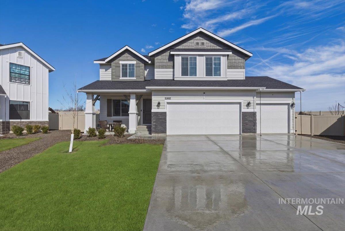Craftsman inspired home featuring stone siding, a garage, concrete driveway, a porch, and a shingled roof