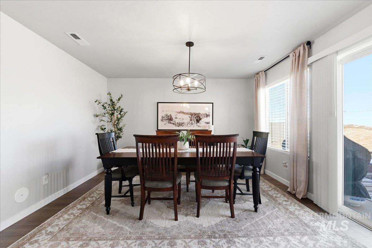 5392 South Memory Way Meridian, ID 83642 - Photo 15 of 39 Dining area featuring light wood-style flooring and a chandelier