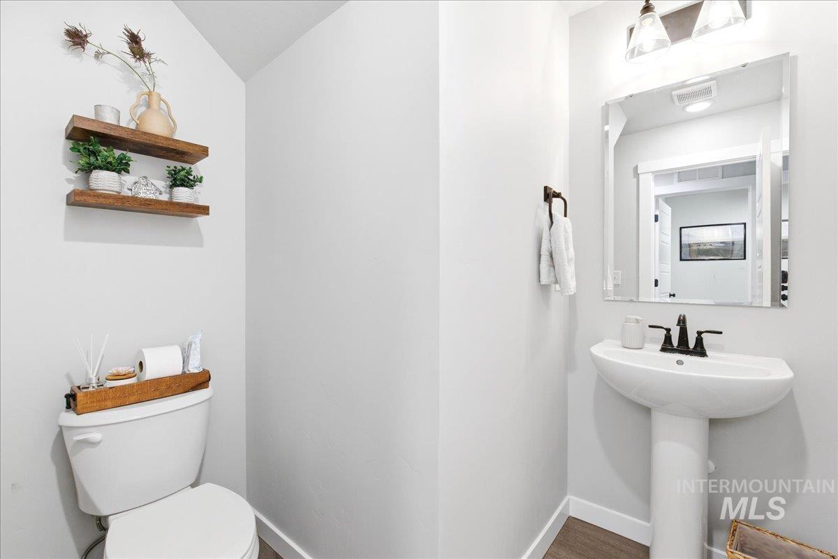 5392 South Memory Way Meridian, ID 83642 - Photo 17 of 39 Bathroom with toilet and dark wood-style floors
