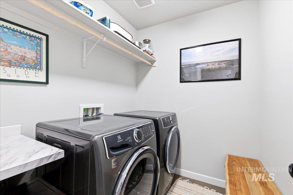 5392 South Memory Way Meridian, ID 83642 - Photo 18 of 39 Laundry area featuring baseboards and separate washer and dryer