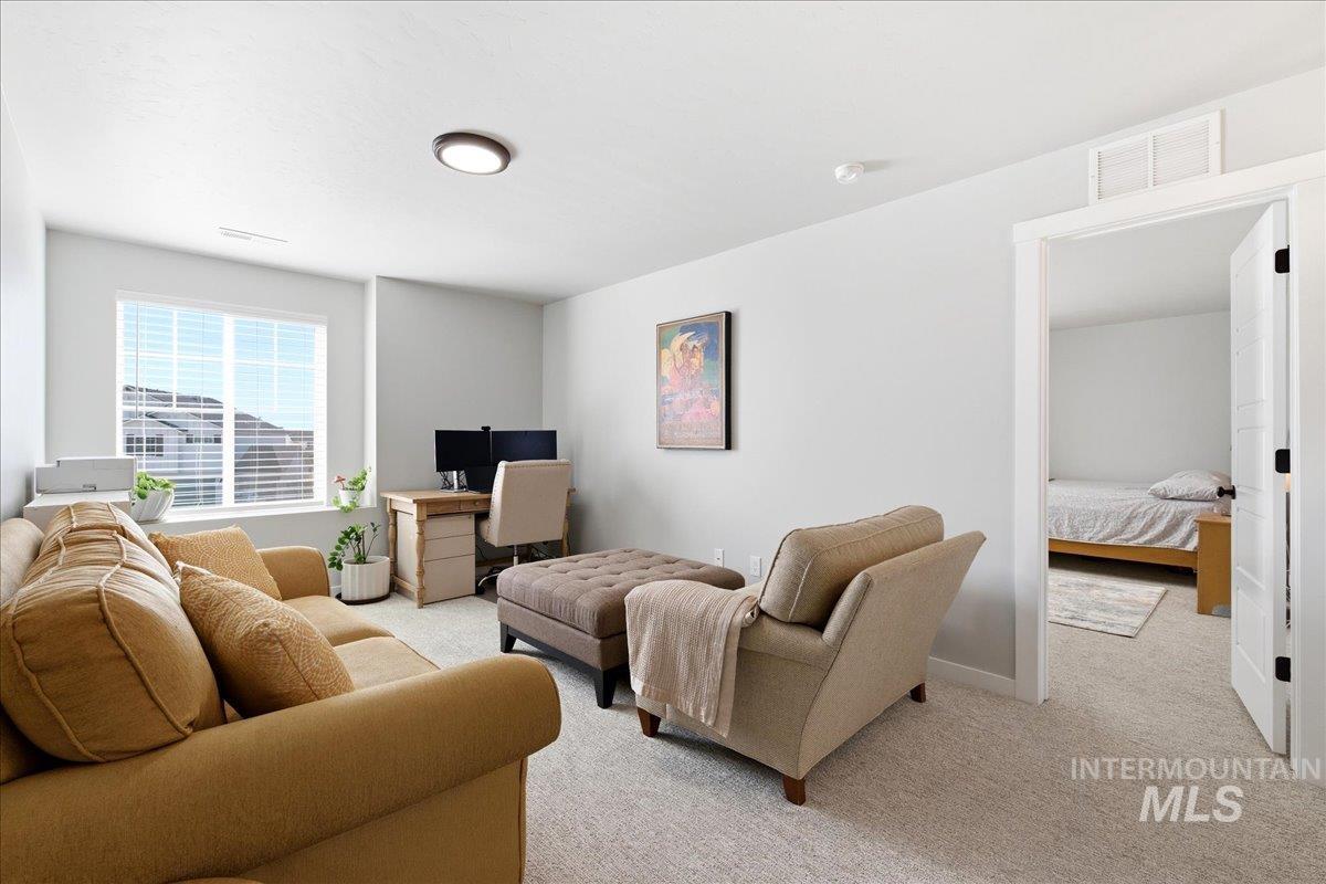 5392 South Memory Way Meridian, ID 83642 - Photo 19 of 39 Living area with light carpet and baseboards