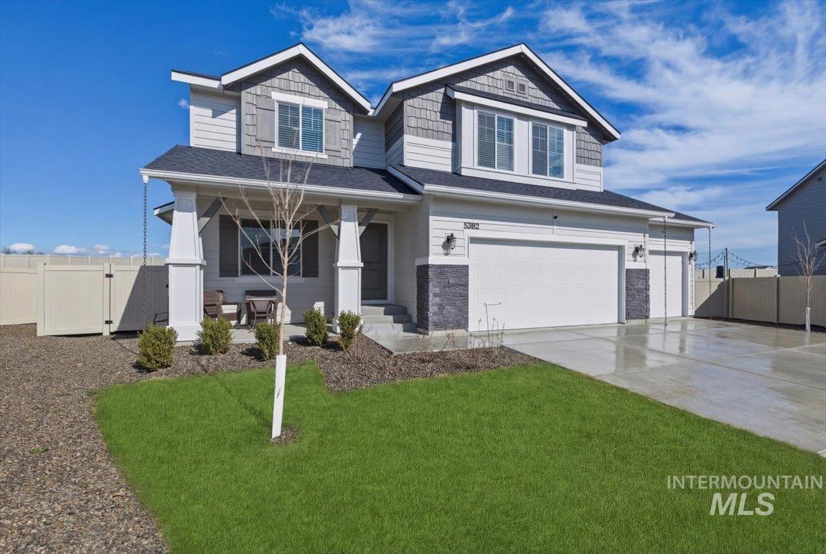 5392 South Memory Way Meridian, ID 83642 - Photo 2 of 39 Craftsman house with a gate, a garage, a porch, concrete driveway, and stone siding