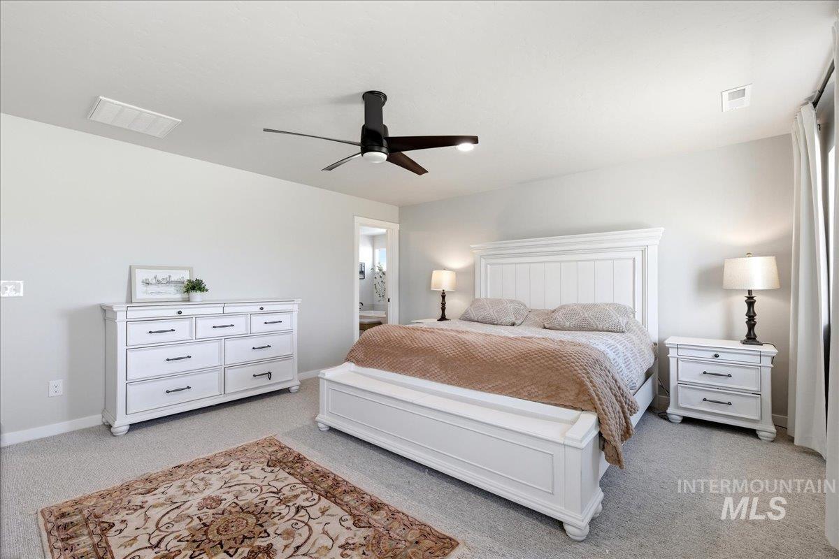5392 South Memory Way Meridian, ID 83642 - Photo 21 of 39 Bedroom with a ceiling fan, light colored carpet, and connected bathroom
