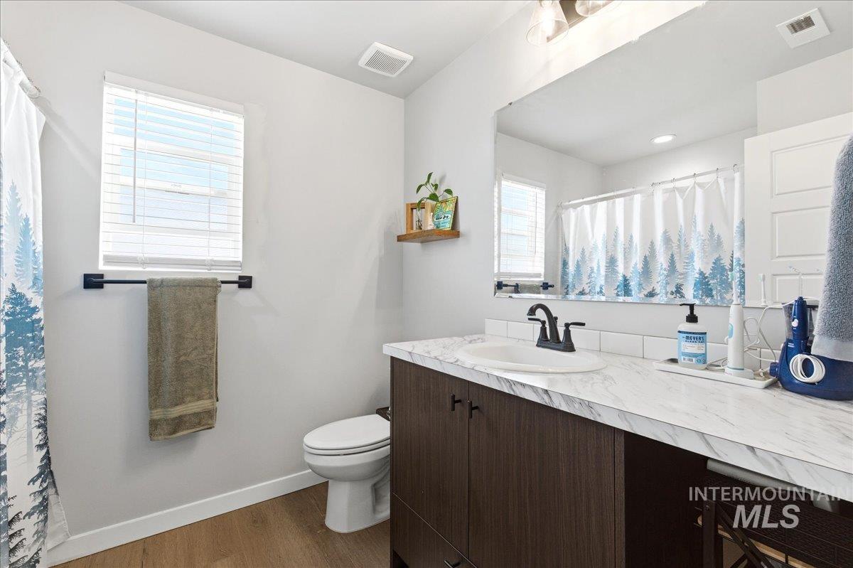 5392 South Memory Way Meridian, ID 83642 - Photo 29 of 39 Bathroom featuring vanity, curtained shower, and dark wood finished floors