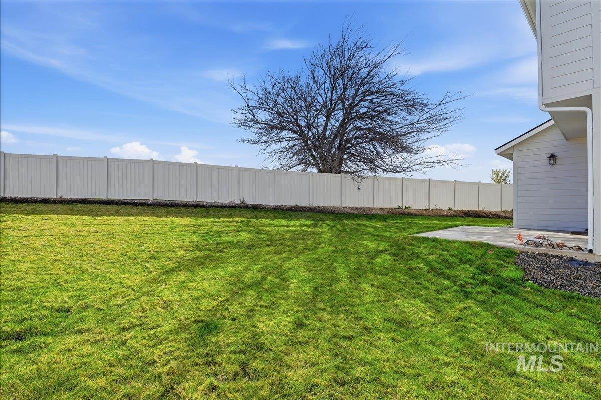 5392 South Memory Way Meridian, ID 83642 - Photo 35 of 39 Expansive green lawn with a white privacy fence