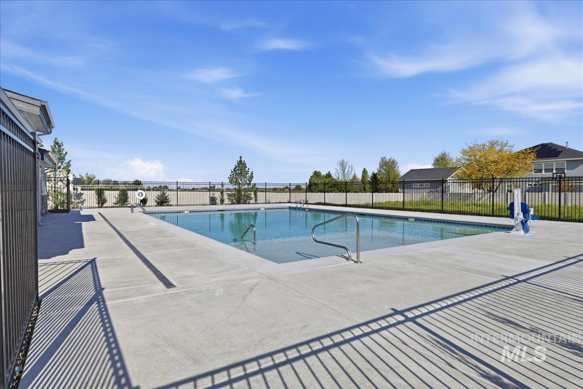 5392 South Memory Way Meridian, ID 83642 - Photo 38 of 39 Outdoor swimming pool surrounded by concrete decking and black metal fencing