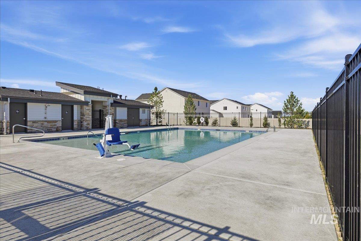 5392 South Memory Way Meridian, ID 83642 - Photo 39 of 39 Outdoor swimming pool with integrated access lift, surrounded by a concrete deck and black metal fencing