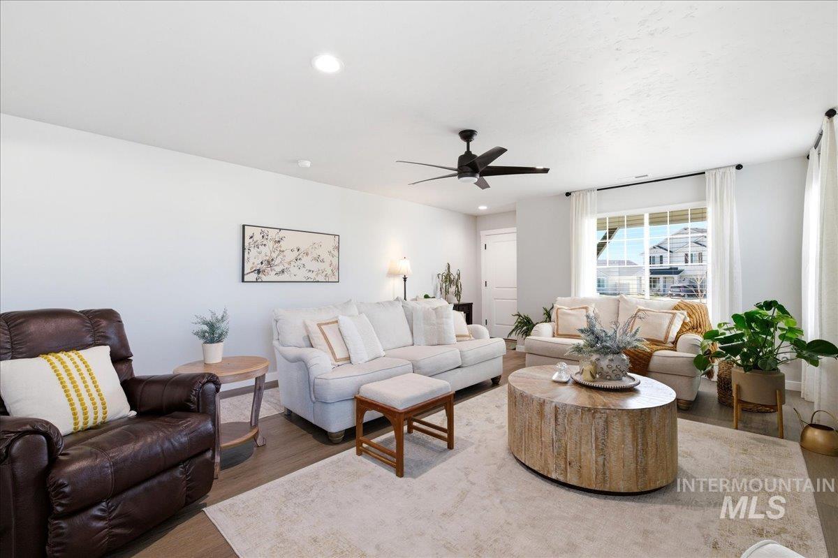 5392 South Memory Way Meridian, ID 83642 - Photo 7 of 39 Living room featuring wood finished floors, a ceiling fan, and recessed lighting