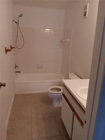 a bathroom with a toilet a sink and a bathtub