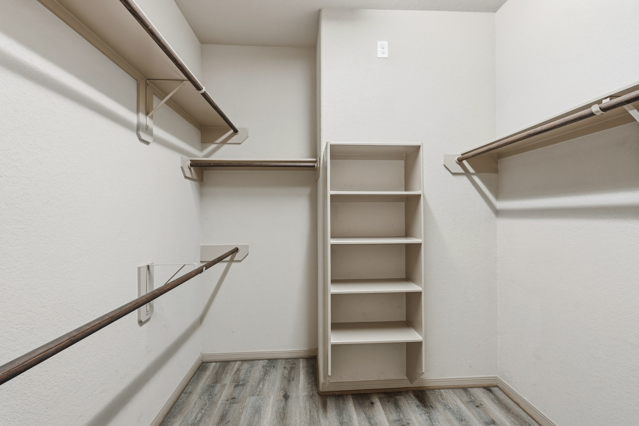 2502 Tiger Eye Drive Rosharon, TX 77583 - Photo 21 of 40 Spacious walk-in closet in the primary suite featuring built-in storage and the same updated LVP flooring as the bedrooms and living room.