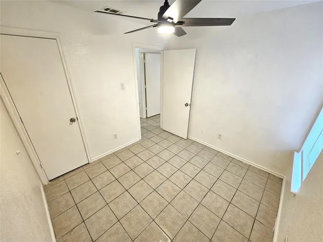 a view of a backyard with plants and large trees