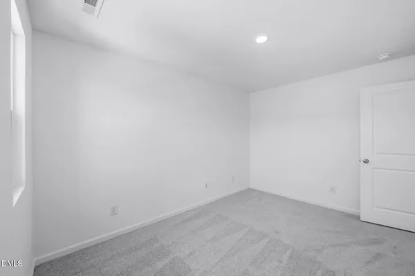 a view of an empty room with white walls