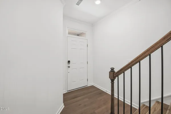 a view of a hallway with wooden floor and entryway