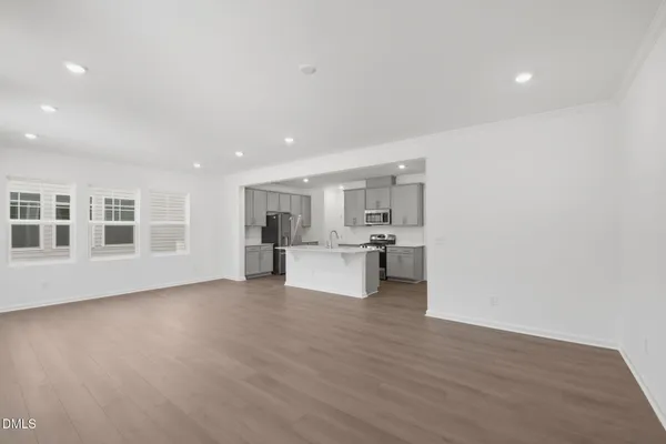 a view of a kitchen with furniture and wooden floor