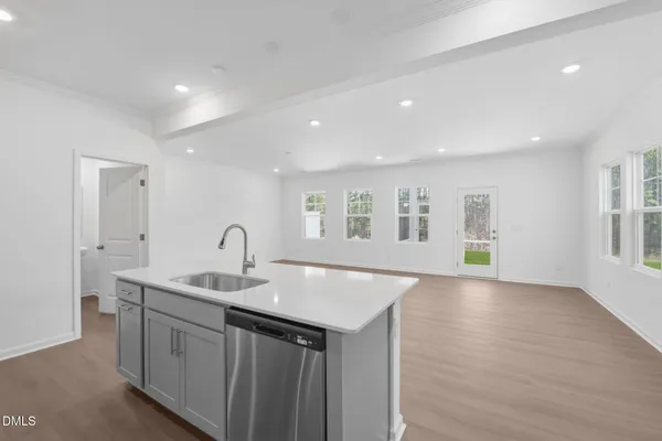 a kitchen with a sink and natural light