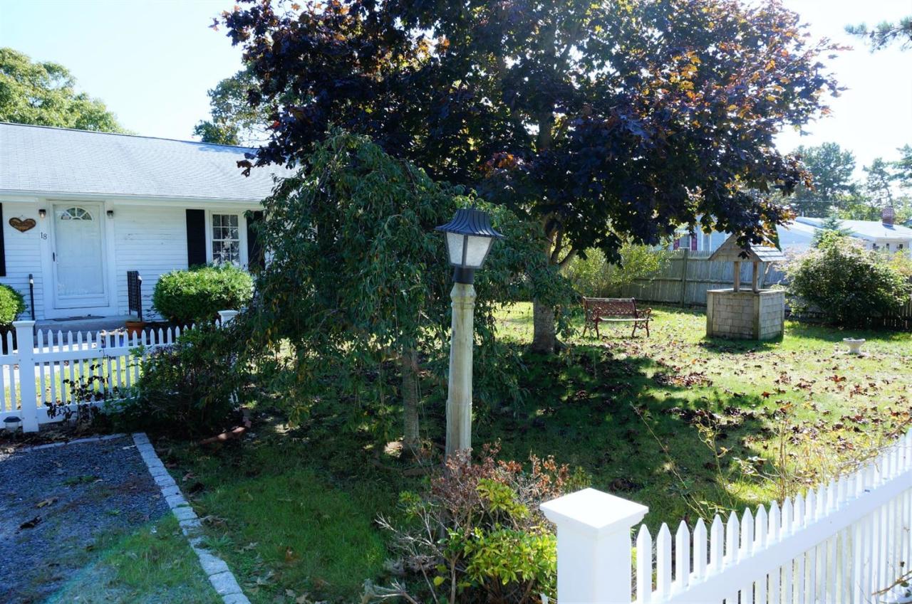 18 Edwards Road Dennis Port, MA 02639 - Photo 2 of 31 a front view of a house with garden