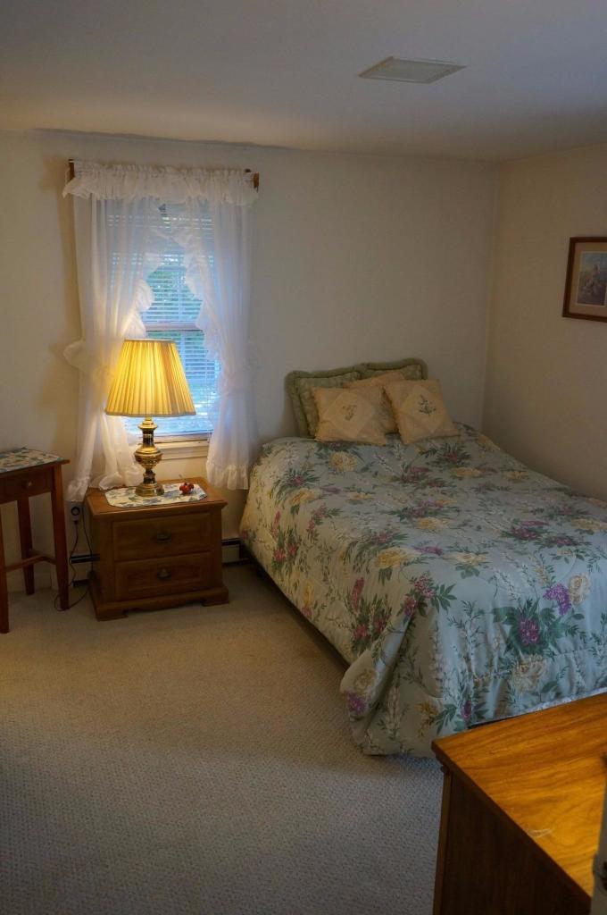 18 Edwards Road Dennis Port, MA 02639 - Photo 28 of 31 a bedroom with a bed and a chair