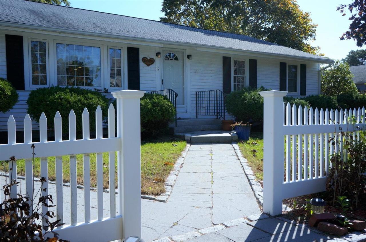 18 Edwards Road Dennis Port, MA 02639 - Photo 5 of 31 a view of a house with a small yard and plants