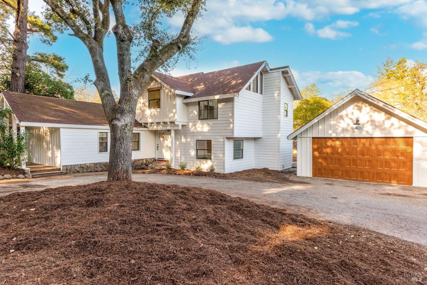 a view of a house with a yard and garage
