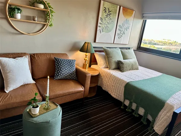 a bedroom with two beds and a window