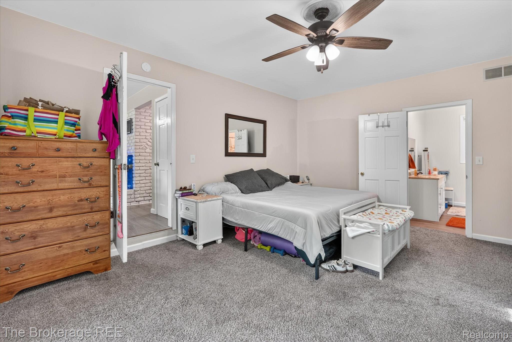 13269 North Genesee Road Clio, MI 48420 - Photo 26 of 67 Carpeted room featuring a ceiling fan with light fixture, light-colored walls, and two white paneled doors