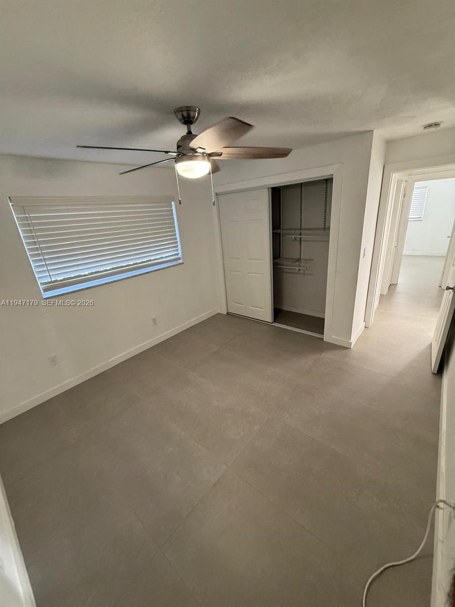 6891 Scott Street Hollywood, FL 33024 - Photo 15 of 28 en empty room with windows and ceiling fan