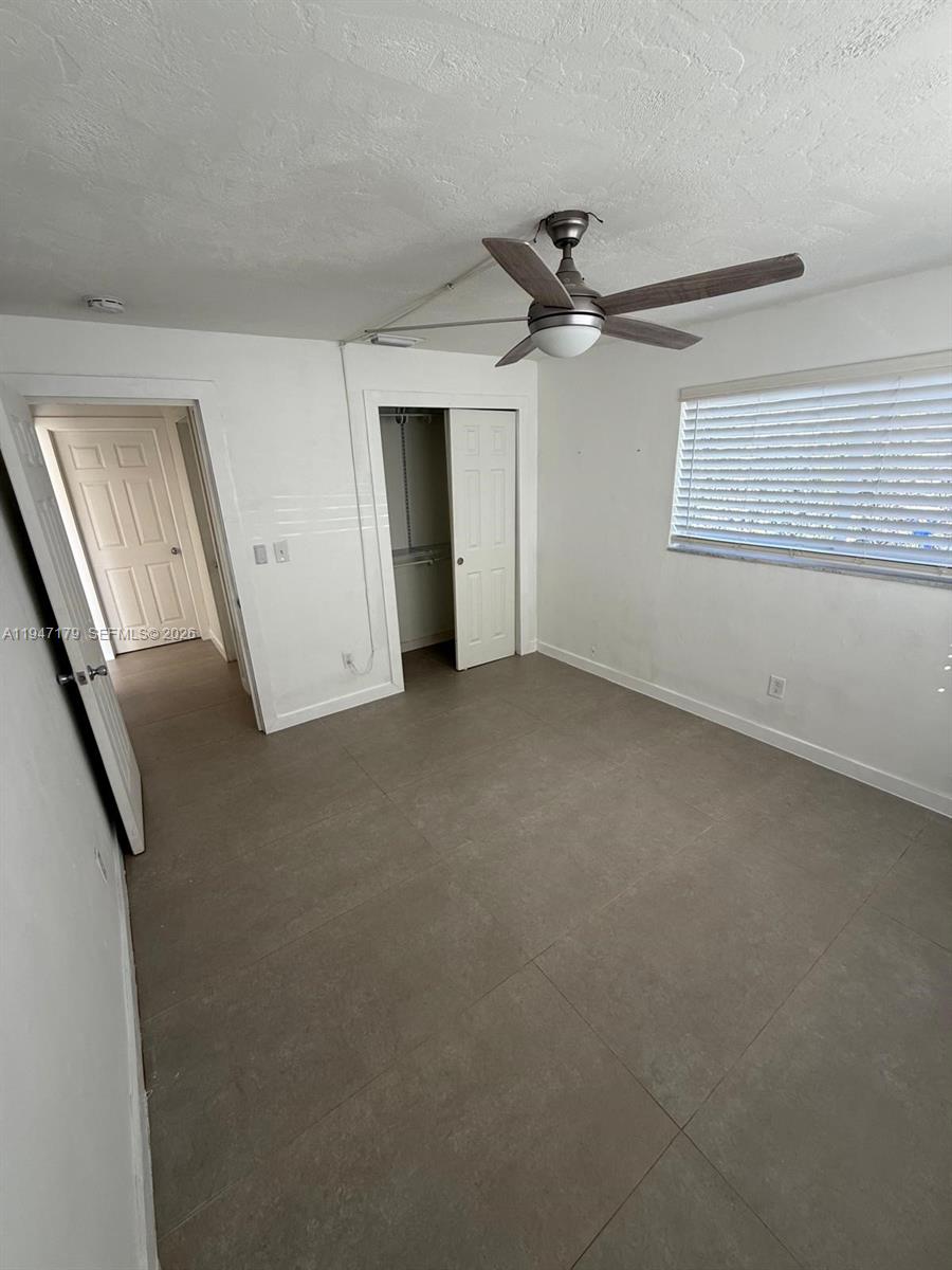 6891 Scott Street Hollywood, FL 33024 - Photo 10 of 28 an empty room with windows and fan