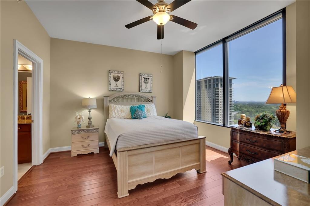 2828 Peachtree Road Northwest, Unit 1901 Atlanta, GA 30305 - Photo 15 of 35 a bedroom with a bed and a table
