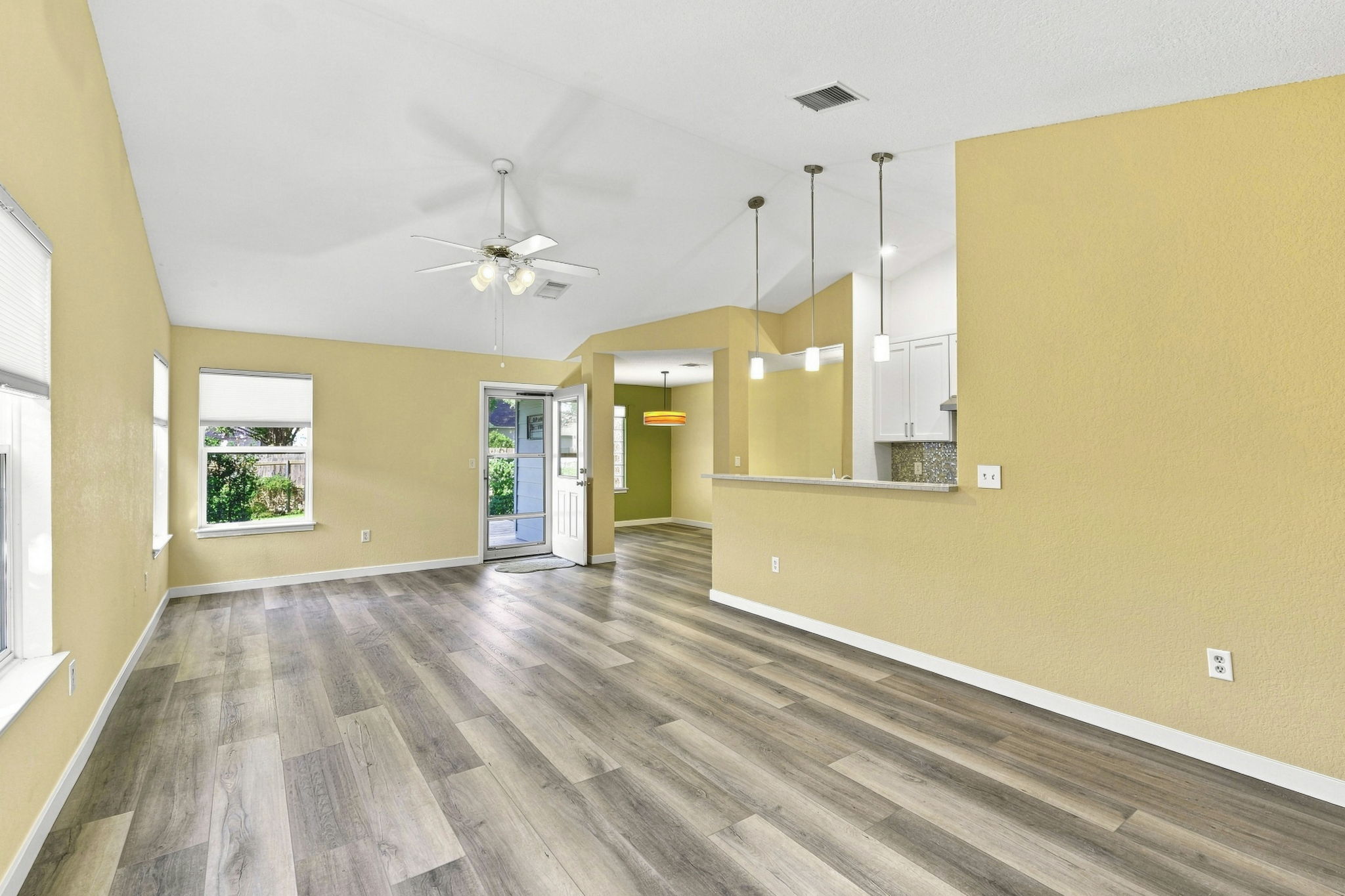 196 Prairie Springs Loop Georgetown, TX 78626 - Photo 9 of 34 Vaulted ceilings and wide-plank flooring define this open living space leading to the totally remodeled kitchen.