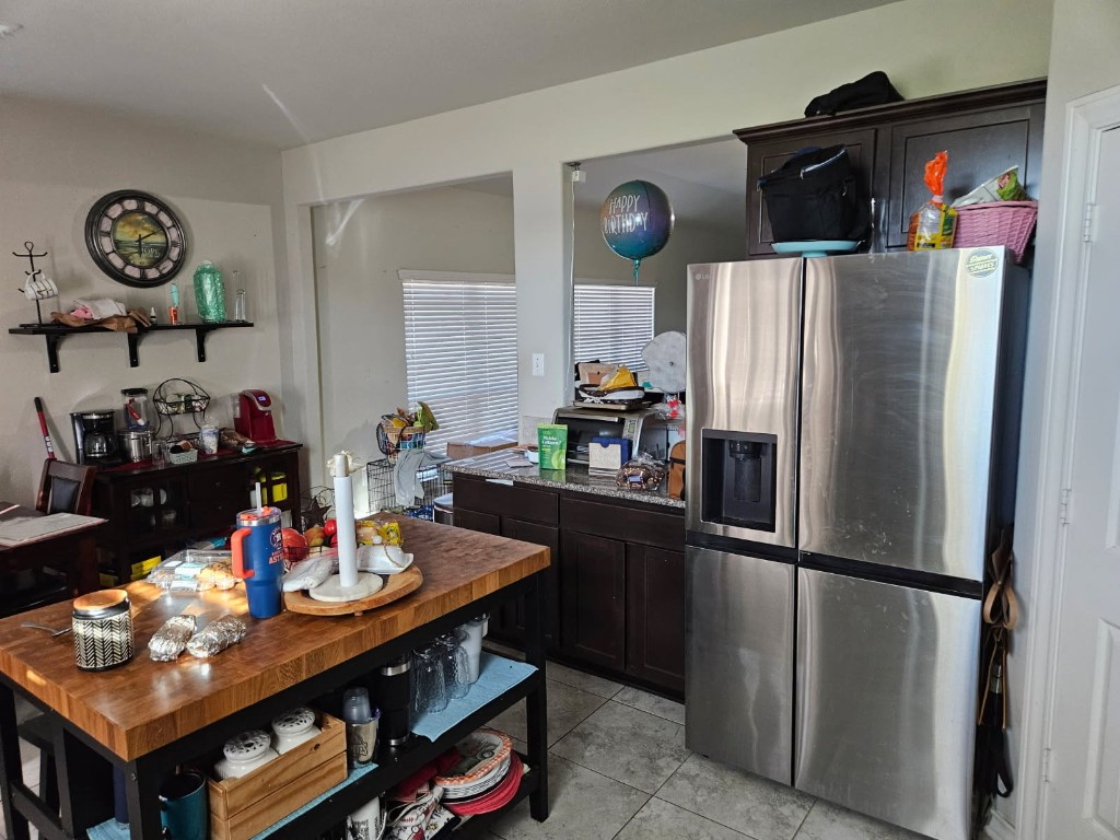 5710 Micah Lane Rosenberg, TX 77471 - Photo 18 of 36 Modern kitchen equipped with a large stainless steel refrigerator and a functional center island for extra prep space.