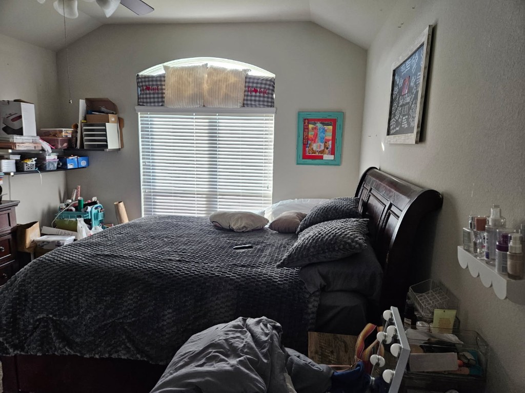 5710 Micah Lane Rosenberg, TX 77471 - Photo 2 of 36 Spacious primary suite featuring vaulted ceilings and a large arched window that floods the room with natural light.