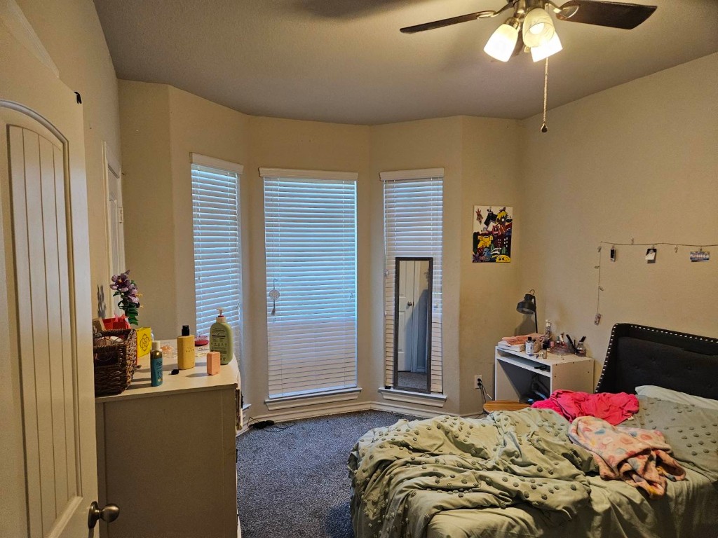5710 Micah Lane Rosenberg, TX 77471 - Photo 23 of 36 Spacious secondary bedroom with a beautiful bay-style window bump-out and cooling ceiling fan.