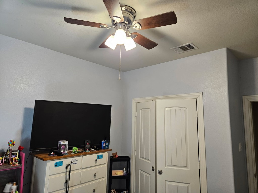 5710 Micah Lane Rosenberg, TX 77471 - Photo 29 of 36 Well-proportioned bedroom featuring neutral carpet, a ceiling fan, and a standard double-door closet.