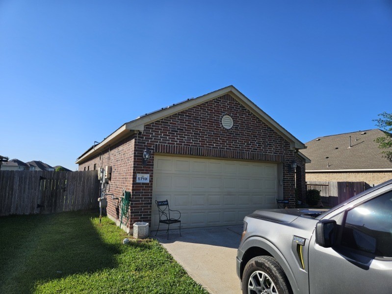 5710 Micah Lane Rosenberg, TX 77471 - Photo 35 of 36 Driveway view with attached garage and fenced side yard.