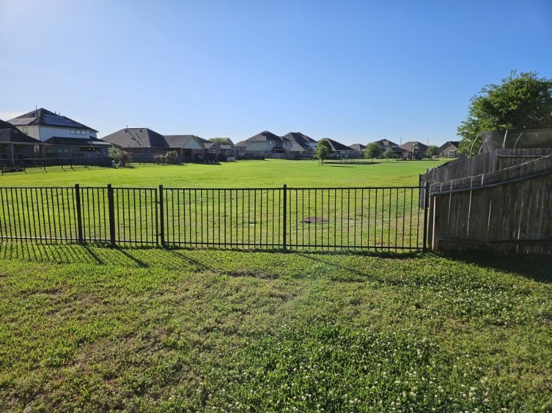 5710 Micah Lane Rosenberg, TX 77471 - Photo 36 of 36 Backyard with open grassy field and fence line view.