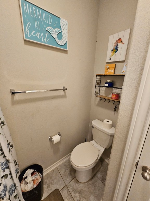 5710 Micah Lane Rosenberg, TX 77471 - Photo 9 of 36 Compact bathroom with toilet and decorative wall accents.